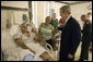 President George W. Bush shares a light moment with Sgt. John Iverson and his wife, Pamela, during the President's visit Friday, July 1, 2005, to Walter Reed Army Medical Center. The Long Beach, California soldier is recovering from injuries sustained while serving in Operation Iraqi Freedom. White House photo by Eric Draper