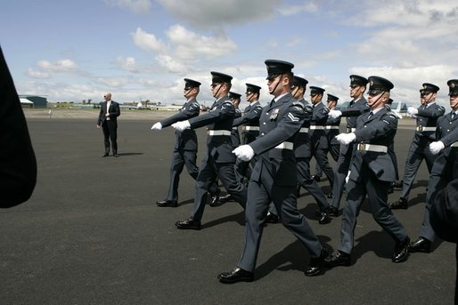 Soldiers parade by President George W. Bush and Laura Bush during an arrival ceremony at Glasgow Prestwick International Airport in Scotland July 6, 2005. White House photo by Krisanne Johnson