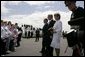 President George W. Bush and Laura Bush are greeted by ceremony and cheers upon their arrival at Glasgow Prestwick International Airport in Scotland July 6, 2005. White House photo by Krisanne Johnson
