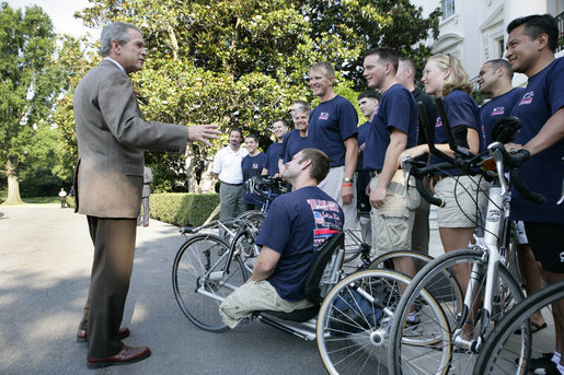 President George W. Bush speaks with members of Soldier Ride 2005 National Tour Team on the South Lawn of the White House, Sunday, July 10, 2005. Soldier Ride 2005, comprised of wounded service members, is a 4,200-mile, cross-country bike ride to raise money and support to help prepare wounded soldiers for long-term rehabilitation. White House photo by Eric Draper