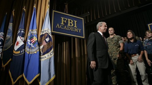 President George W. Bush walks on stage Monday, July 11, 2005, at the FBI Academy in Quantico, Va., where he spoke on the ongoing accomplishments and efforts in the war on terror. White House photo by Eric Draper