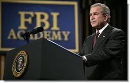 President George W. Bush delivers remarks about key accomplishments and the ongoing efforts in the war on terrorism during a visit Monday, July 11, 2005, to the FBI Academy in Quantico, Va. Said the President, "The FBI efforts are central to our success in the war on terror. And I thank you for that."  White House photo by Eric Draper