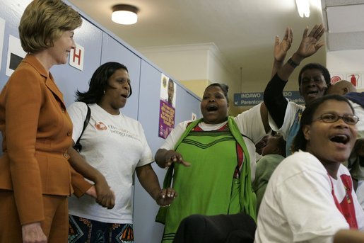 Laura Bush is greeted by a chorus of singers while visiting Mothers to Mothers-to-Be in Cape Town, South Africa, Tuesday, July 12. The program provides counseling, education and support to HIV/AIDS infected women during pregnancy. White House photo by Krisanne Johnson