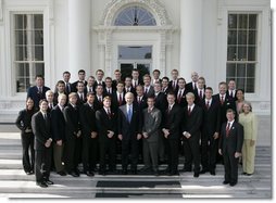 President George W. Bush stands with members of the Auburn University Men's Swimming and Diving team during Championship Day at the White House Tuesday, July 12, 2005.  White House photo by Eric Draper