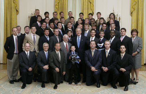 President George W. Bush stands with members of Johns Hopkins University's Men's Lacrosse team Tuesday, July 12, 2005, during Championship Day at the White House. White House photo by David Bohrer