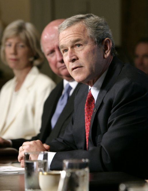 President Bush speaks to news reporters, Wednesday, July 13, 2005, prior to the start of a cabinet meeting at the White House. In background from left to right are cabinet members Secretary of Interior Gale Norton and Secretary of Energy Samuel W. Bodman. White House photo by Eric Draper
