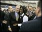 President George W. Bush greets the audience following remarks at the Indiana Black Expo Corporate Luncheon in Indianapolis, Indiana, Thursday, July 14, 2005.  White House photo by Eric Draper