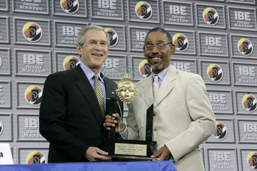 President George W. Bush receives the Black Expo Lifetime Achievement Award by Black Expo Chairman Arvis Dawson during the Indiana Black Expo Corporate Luncheon in Indianapolis, Indiana, Thursday, July 14, 2005. White House photo by Eric Draper