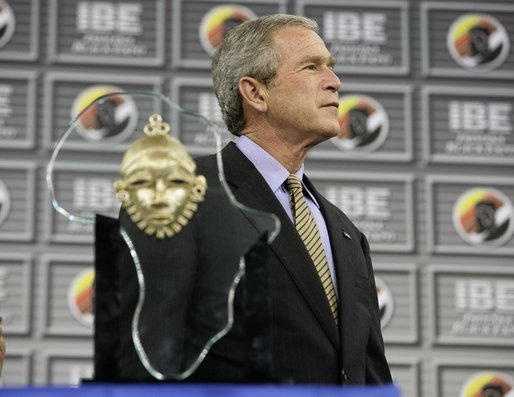 President George W. Bush stands on stage before receiving the Indiana Black Expo Lifetime Achievement Award at the Indiana Black Expo Corporate Luncheon in Indianapolis, Indiana, Thursday, July 14, 2005. White House photo by Eric Draper