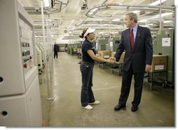 President George W. Bush greets a worker during a tour of R.I. Stowe Mills - Helms Plant in Belmont, N.C., Friday, July 15, 2005.  White House photo by Eric Draper
