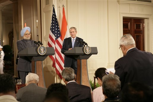 President George W. Bush and India's Prime Minister Dr. Manmohan Singh, listen to a reporter's question during a joint news conference, Monday, July 18, 2005, in the East Room of the White House. White House photo by Eric Draper