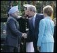 President George W. Bush and Laura Bush welcome India's Prime Minister Dr. Manmohan Singh upon his arrival to the Whiite House, Monday, July 18, 2005. White House photo by Eric Draper
