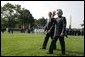 President George W. Bush walks with India's Prime Minister Dr. Manmohan Singh , Monday, July 18, 2005, on the South Lawn of the White House, during Singh's official arrival ceremony. White House photo by David Bohrer