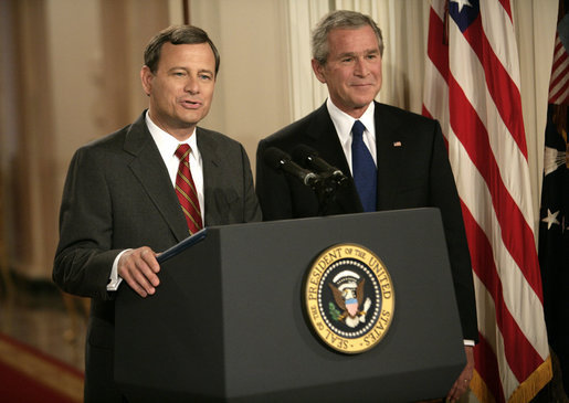 President George W. Bush looks on as his Supreme Court Justice Nominee John Roberts delivers remarks on the State Floor of the White House, Tuesday evening, July 19, 2005. White House photo by Eric Draper