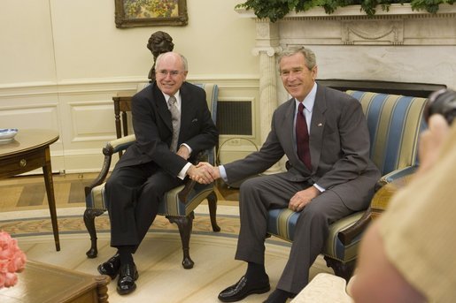 President George W. Bush shakes hands with Prime Minister John Howard of Australia, as he welcomes the Prime Minister to the Oval Office Tuesday, July 19, 2005, at the White House. White House photo by Carolyn Drake