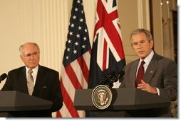 President George W. Bush gestures as he answers a reporter's question Tuesday, July 19, 2005, during a joint press availability with Australia's Prime Minister John Howard in the East Room of the White House.  White House photo by Carolyn Drake