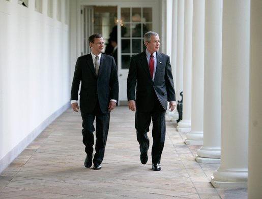 President George W. Bush walks along the Colonnade with Judge John G. Roberts, the President's nominee to the Supreme Court, during an early morning visit Wednesday, July 20, 2005, to the White House. White House photo by Eric Draper