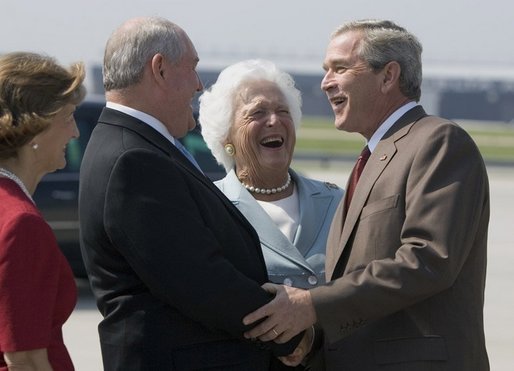 President George W. Bush and his mother Barbara Bush are greeted by Georgia Governor Sonny Perdue, upon their arrival to Atlanta, Friday, July 22, 2005, to attend events to talk about Social Security and Medicare. White House photo by Paul Morse