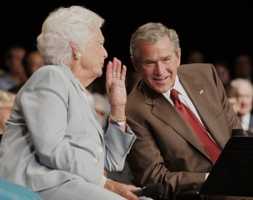 President George W. Bush talks to his mother Barbara Bush, Friday, July 22, 2005, during their appearance at a Conversation on Senior Security at the Boisfeuillet Jones Civic Center in Atlanta, to talk about Social Security and Medicare. White House photo by Paul Morse