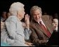 President George W. Bush talks to his mother Barbara Bush, Friday, July 22, 2005, during their appearance at a Conversation on Senior Security at the Boisfeuillet Jones Civic Center in Atlanta, to talk about Social Security and Medicare. White House photo by Paul Morse