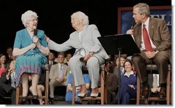 President George W. Bush and his mother Barbara Bush talk with Social Security recipient Frances Heverly, left, Friday, July 22, 2005, during a Conversation on Senior Security at the Boisfeuillet Jones Civic Center in Atlanta, to talk about Social Security and Medicare.  White House photo by Paul Morse