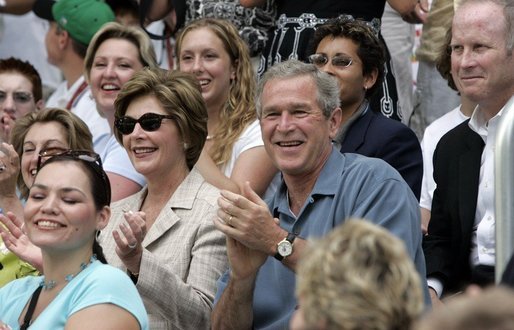 President George W. Bush and Mrs. Laura Bush cheers on players during a Tee Ball game on the South Lawn of the White House between the District 12 Little League Challengers from Williamsport, PA and the West University Little League Challengers from Houston, Texas on Sunday July 24, 2005. White House photo by Paul Morse