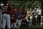 President George W. Bush welcomes players and their family members from the West University Little League Challengers from Houston, Texas, and the District 12 Little League Challengers from Williamsport, Pa., Sunday, July 24, 2005, at a Tee Ball game on the South Lawn of the White House. White House photo by Carolyn Drake