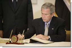 President George W. Bush signs the condolence book at the Egyptian Embassy, Monday, July 25. 2005 in Washington, expressing heart-felt sympathies for those who have lost their lives and were injured in the terror bombing in Sharm el-Sheikh, Egypt.  White House photo by Eric Draper