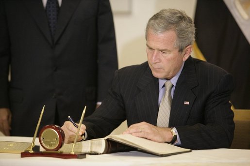 President George W. Bush signs the condolence book at the Egyptian Embassy, Monday, July 25. 2005 in Washington, expressing heart-felt sympathies for those who have lost their lives and were injured in the terror bombing in Sharm el-Sheikh, Egypt. White House photo by Eric Draper