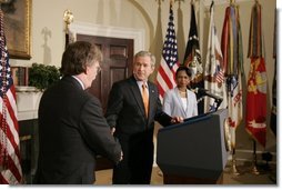 With Dr. Condoleezza Rice looking on, President George W. Bush shakes the hand of John Bolton after nominating him Monday, Aug. 1, 2005, as the U.S. Ambassador to the United Nations.  White House photo by Paul Morse
