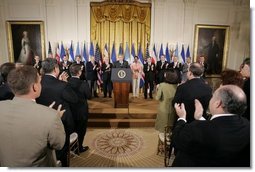 President George W. Bush acknowledges the applause of legislators, administration officials and guests, Tuesday, Aug. 2. 2005 in the East room of the White House, at the signing ceremony for the CAFTA Implementation Act.  White House photo by Paul Morse