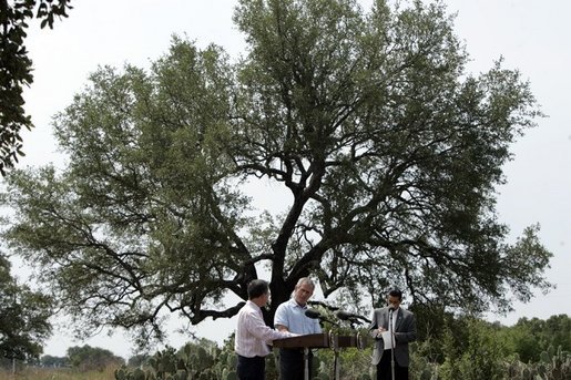 President George W. Bush and Colombian President Alvaro Uribe shake during a joint press conference at the President's Central Texas ranch in Crawford, Texas, on August 4, 2005. White House photo by Paul Morse