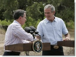 President George W. Bush and Colombian President Alvaro Uribe shake hands during a joint press conference at the President's Central Texas ranch in Crawford, Texas, on August 4, 2005.  White House photo by Paul Morse