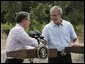 President George W. Bush and Colombian President Alvaro Uribe shake hands during a joint press conference at the President's Central Texas ranch in Crawford, Texas, on August 4, 2005. White House photo by Paul Morse