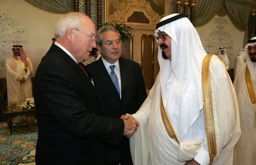 Former President George H. W. Bush, left, shake hands with newly crowned King Abdullah, right, during a retreat at King Abdullah's Farm in Riyadh, Saudi Arabia Friday, August 5, 2005, following the death of his half-brother King Fahd who passed away August 1, 2005. Interperter Gamal Helal, center, is also pictured. White House photo by David Bohrer