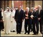 Vice President Dick Cheney and former President George H.W. Bush walks with newly crowned King Abdullah during a retreat at King Abdullah's Farm in Riyadh, Saudi Arabia Friday, August 5, 2005, following the death of his half-brother King Fahd who passed away August 1, 2005. Interpreter Gamal Helal, center, is also pictured.  White House photo by David Bohrer