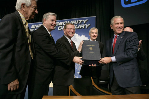 President George W. Bush holds the box containing the energy bill after signing the H.R. 6, The Energy Policy Act of 2005 at Sandia National Laboratory in Albuquerque, New Mexico, Monday, Aug. 8, 2005. Also on stage from left are Congressman Ralph Hall (R, TX), Congressman Joe Barton (R, TX), Senator Pete Domenici (R, NM) and Senator Jeff Bingaman (D, NM). White House photo by Eric Draper