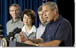 President George W. Bush addresses a news conference, Tuesday, Aug. 9, 2005 at the Bush Ranch in Crawford, Texas, following a meeting to discuss the strength of the U.S. economy. At left are economic policy advisors U.S. Trade Representative Rob Portman; U.S. Secretary of Labor Elaine Chao and U.S. Secretary of Agriculture Mike Johanns.  White House photo by Paul Morse