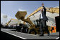 President George W. Bush acknowledges the applause of the crowd as he arrives to sign the Transportation Equity Act, at the Caterpillar facility in Montgomery, Ill., Wednesday, Aug. 10, 2005. White House photo by Eric Draper