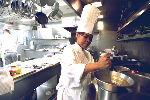 Chef Cristeta "Cris" Comerford prepares a meal inside the White House kitchen in this July 17, 2002 photo. Mrs. Laura Bush announced on August 14, 2005 that Comerford has been named the White House Executive Chef. Comerford is the first woman to serve in the job. White House photo by Tina Hager