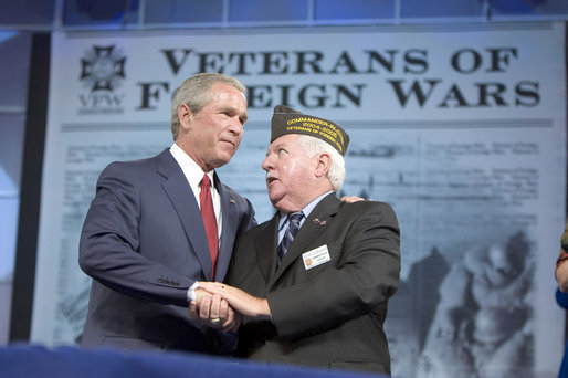 President George W. Bush talks with Veterans of Foreign Wars Commander-in-chief John Furgess during his visit to the VFW national convention in Salt Lake City, Utah, August 22, 2005. White House photo by Paul Morse