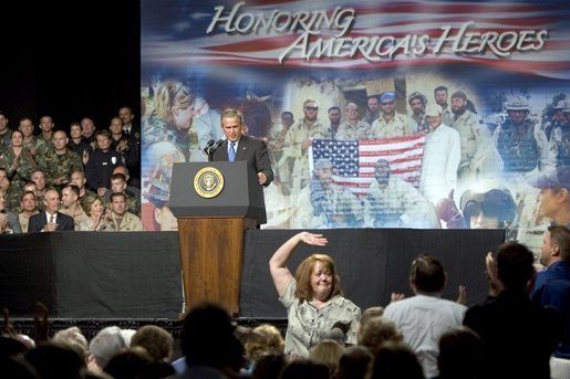 The mother of four sons currently deployed to Iraq, Tammy Pruett, acknowledges the applause of the crowd at Idaho Center Arena, Wednesday, Aug. 24, 2005 in Nampa, Idaho, after she is introduced by President George W. Bush. White House photo by Paul Morse