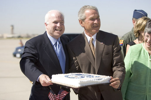 President George W. Bush joins Arizona Senator John McCain in a small celebration of McCain's 69th birthday Monday, Aug. 29, 2005, after the President's arrival at Luke Air Force Base near Phoenix. The President later spoke about Medicare to 400 guests at the Pueblo El Mirage RV Resort and Country Club in nearby El Mirage. White House photo by Paul Morse