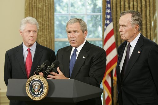 Standing with former Presidents Bill Clinton and George H. W. Bush, President George W. Bush discusses the plans to help people affected by Hurricane Katrina in the Oval Office Sept. 1, 2005. "We're working hard to repair the breaches in the levees. Federal, state, and local agencies are also cooperating to sustain life," President Bush. "That means getting food and water to those who are stranded. Medical personnel and local officials are helping hospital patients and people gathered in the Superdome to evacuate." White House photo by Paul Morse