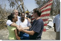 President George W. Bush embraces victims of Hurricane Katrina Friday, Sept. 2, 2005, during his tour of the Biloxi, Miss., area. " The President told residents that he had come down to look at the damage first hand and to tell the "good people of this part of the world that the federal government is going to help."  White House photo by Eric Draper