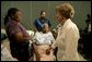 Laura Bush reaches out to a victim of Hurricane Katrina during a visit Friday, Sept. 2, 2005, to the Cajundome at the University of Louisiana in Lafayette. "The people of this part of the United States, the Lafayette area of Louisiana, are very, very warm people," said Mrs. Bush. "They've opened their hearts, and many of them have opened their homes, as well, to people from New Orleans -- family members and strangers." White House photo by Krisanne Johnson