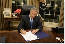 President George W. Bush signs legislation in the Oval Office Friday, Sept. 2, 2005, to provide 10.5 billion dollars in relief aid for the areas along the Gulf Coast affected by Hurricane Katrina. Congress approved the bill late Thursday.  White House photo by Paul Morse