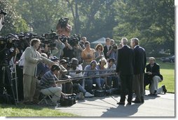 President George W. Bush and Michael Chertoff, Secretary of Homeland Security, talk with the media Friday, Sept. 2, 2005, on the South Lawn of the White House. The President briefed the press on hurricane disaster relief before departing for a tour of the Gulf Coast area hit by Hurricane Katrina.  White House photo by Paul Morse