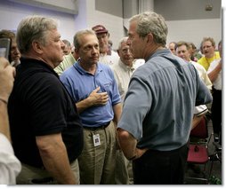 President George W. Bush talks with Mississippi Governor Haley Barbour, far left, and other state officials in Poplarville, Miss., during a visit Monday, Sept. 5, 2005 to the Gulf Coast region. White House photo by Eric Draper