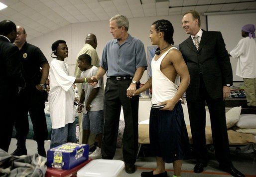 President George W. Bush visits with children inside the Bethany World Prayer Center shelter, Monday, Sept. 5, 2005 in Baton Rouge, Louisiana. The facility is housing hundreds of people displaced by Hurricane Katrina. White House photo by Eric Draper
